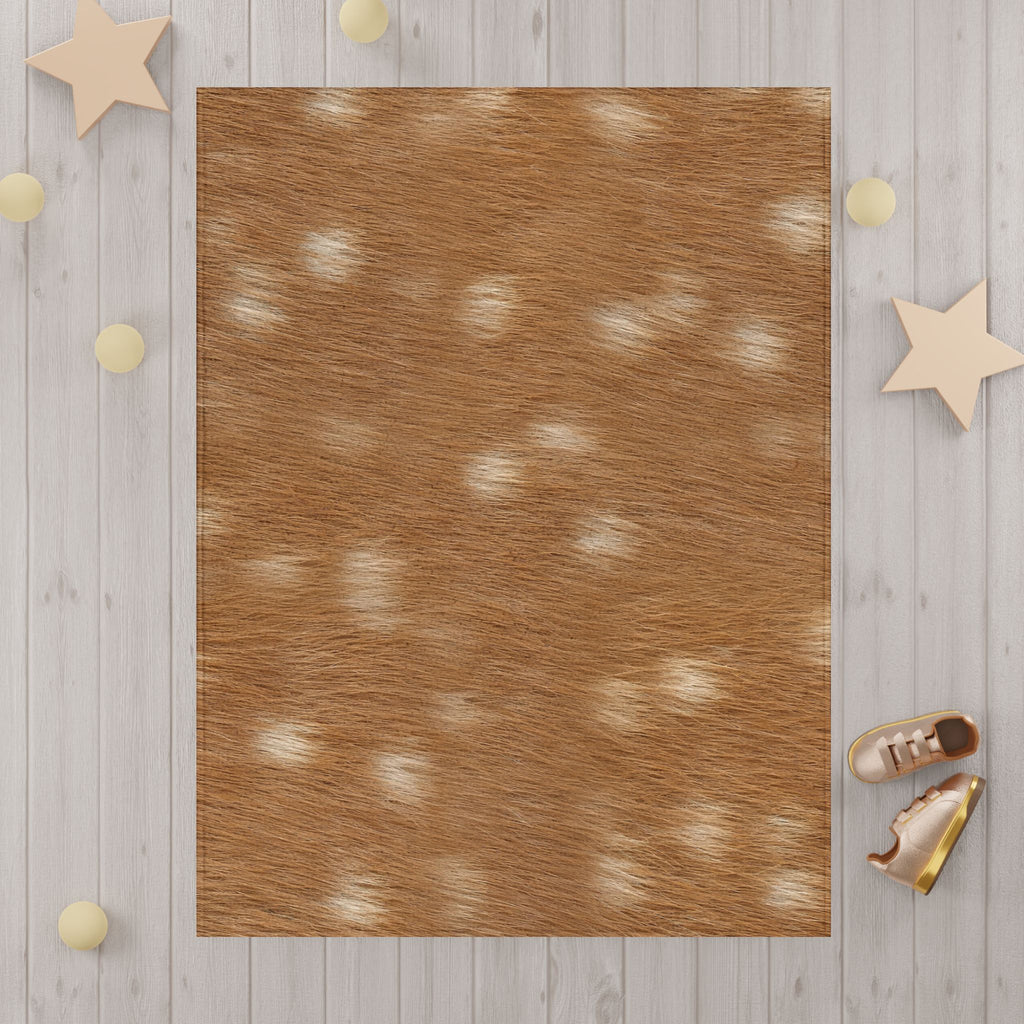 Fawn deer print blanket detail — creamy white dapples on russet tan