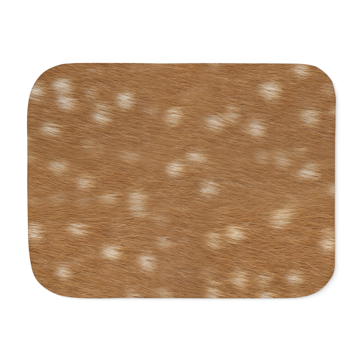 Spotted deer print sherpa blanket styled on a neutral sofa