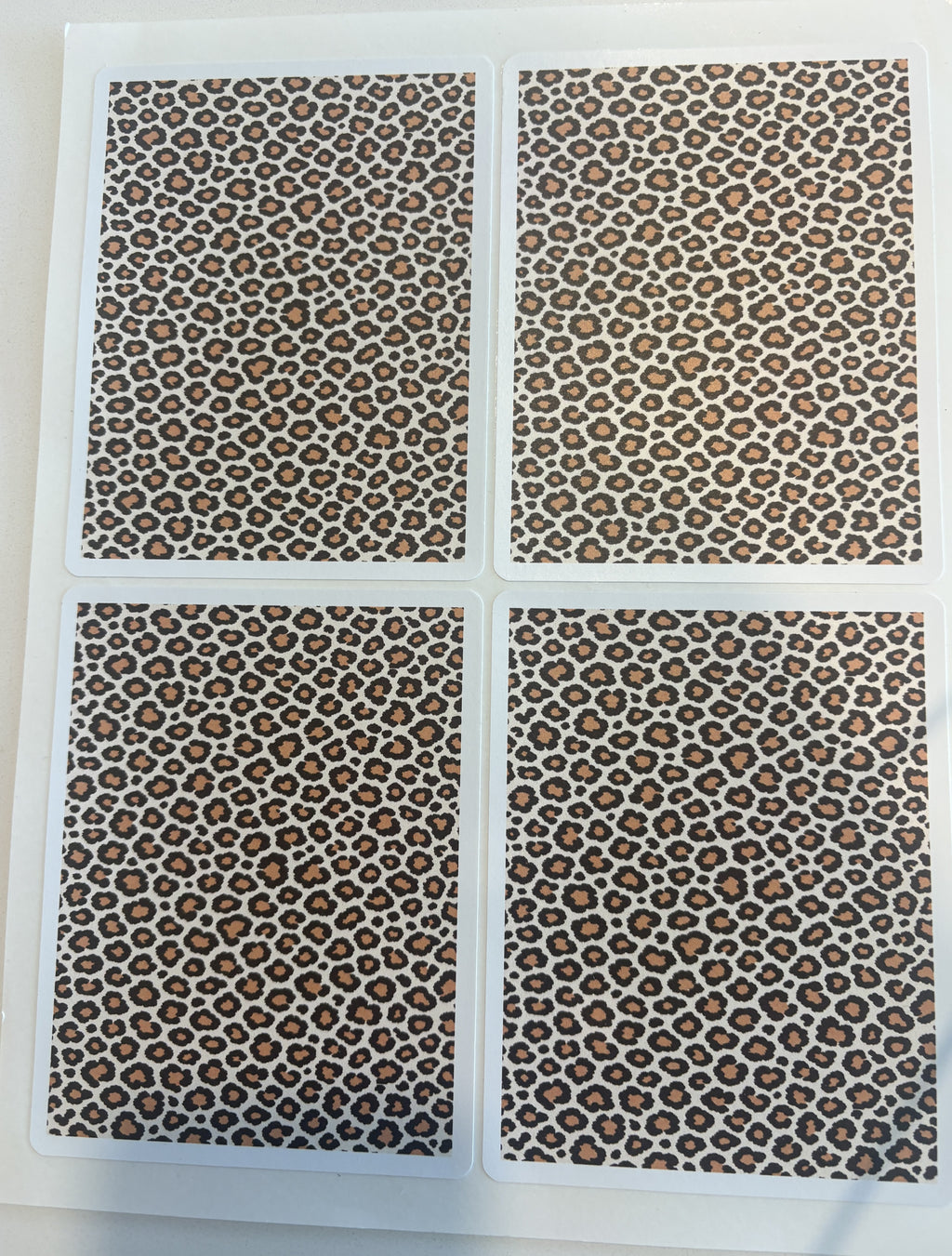 Leopard print sticker sheet in warm-neutral tones — four die-cut leopard panels