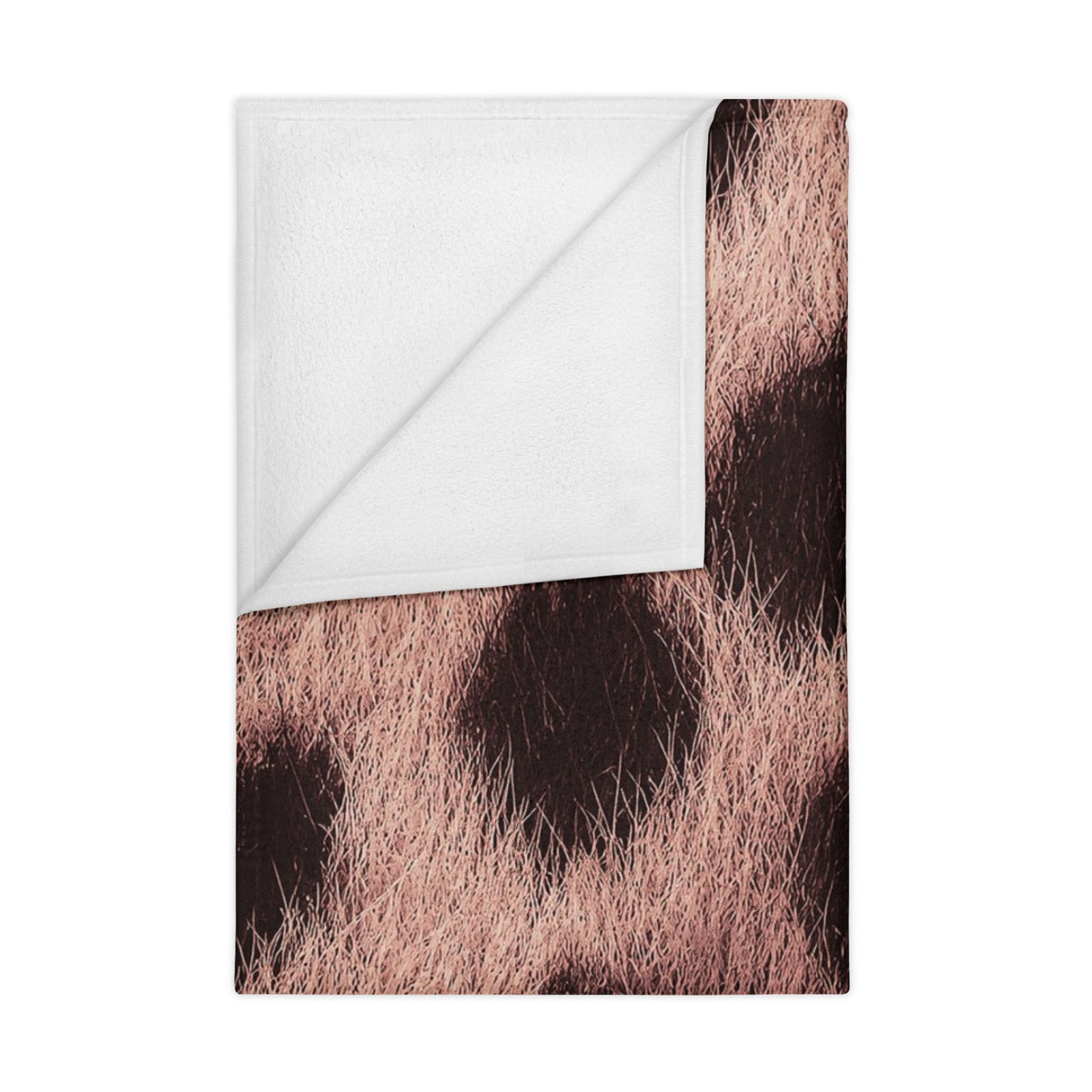 Soft pink leopard print toddler blanket in a girl's nursery