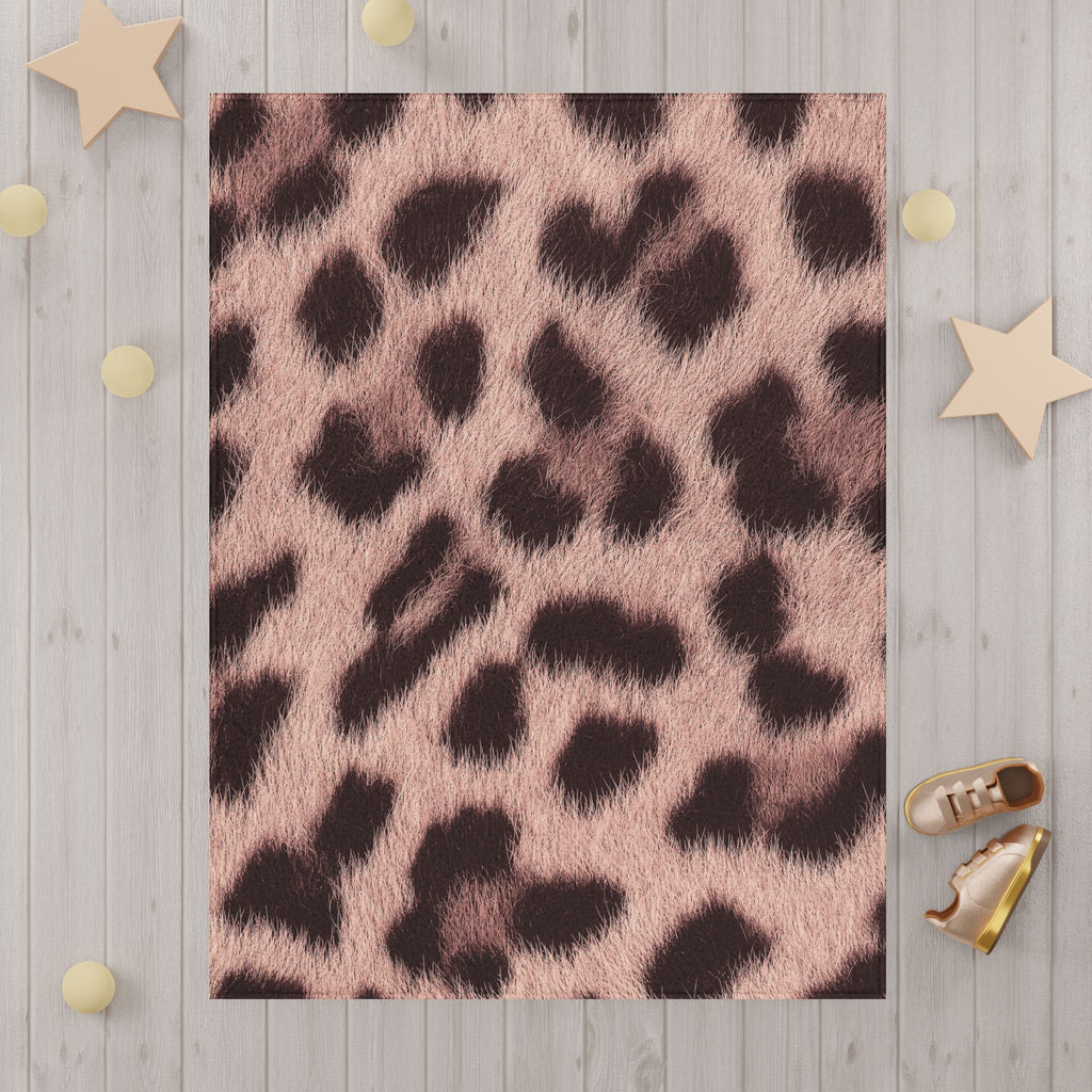 Blush leopard print blanket detail — soft pink rosettes and hair strands