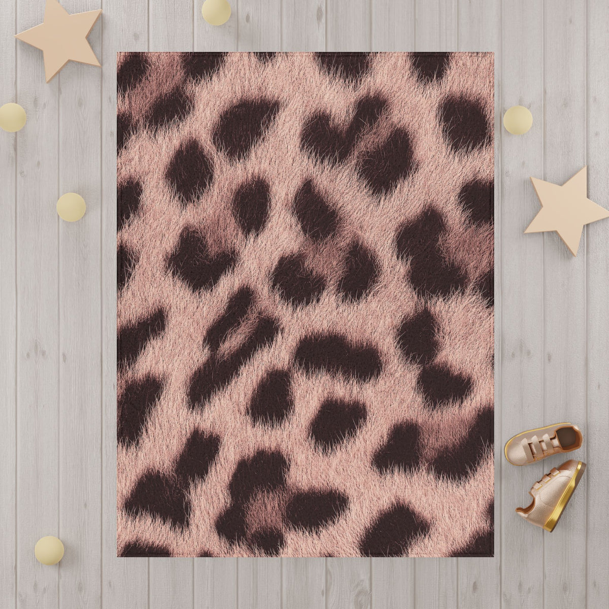 Blush leopard print blanket detail — soft pink rosettes and hair strands