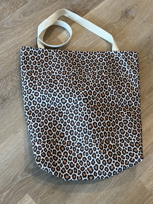 Tawny leopard print tote bag in warm cream — real product photo, flat lay