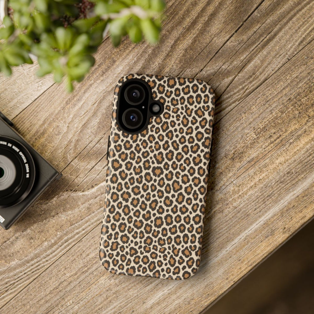 Leopard print phone case on a wooden table — Tawny classic tan tough case