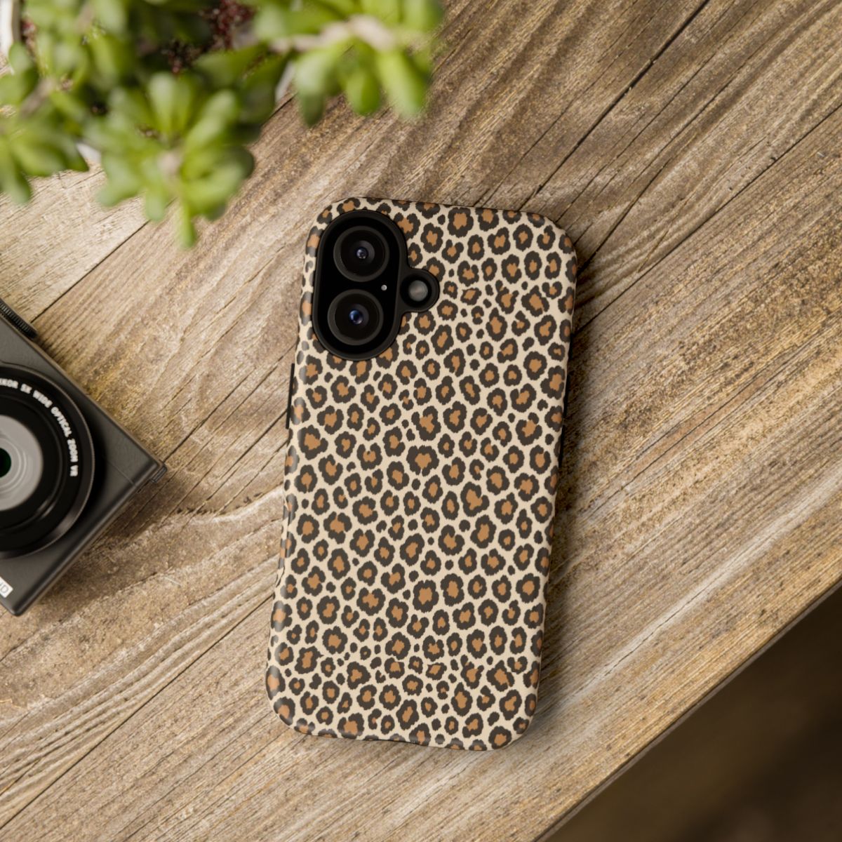 Leopard print phone case on a wooden table — Tawny classic tan tough case