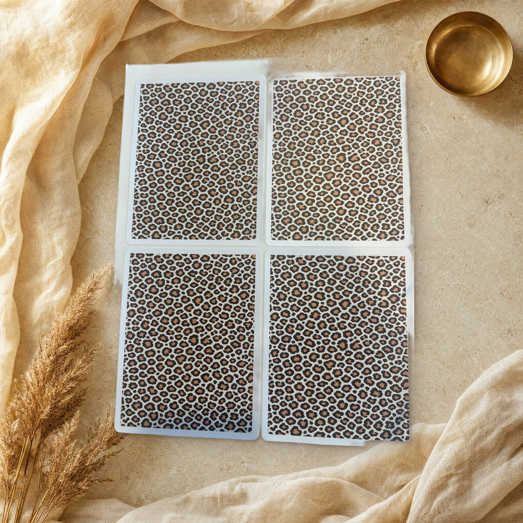 Classic cream leopard print sticker sheet with four die-cut panels on travertine stone