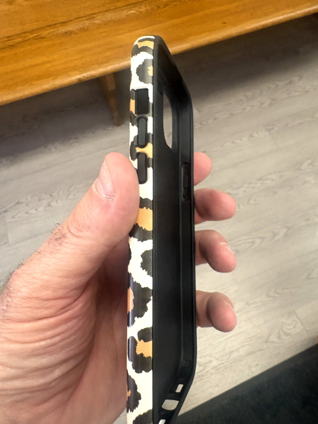 Leopard print phone case side view — edge-to-edge print and covered buttons